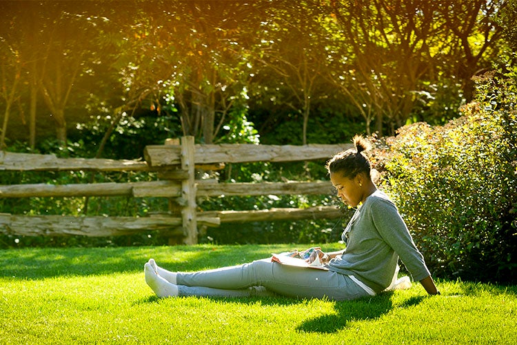 Student taking a break on the grass