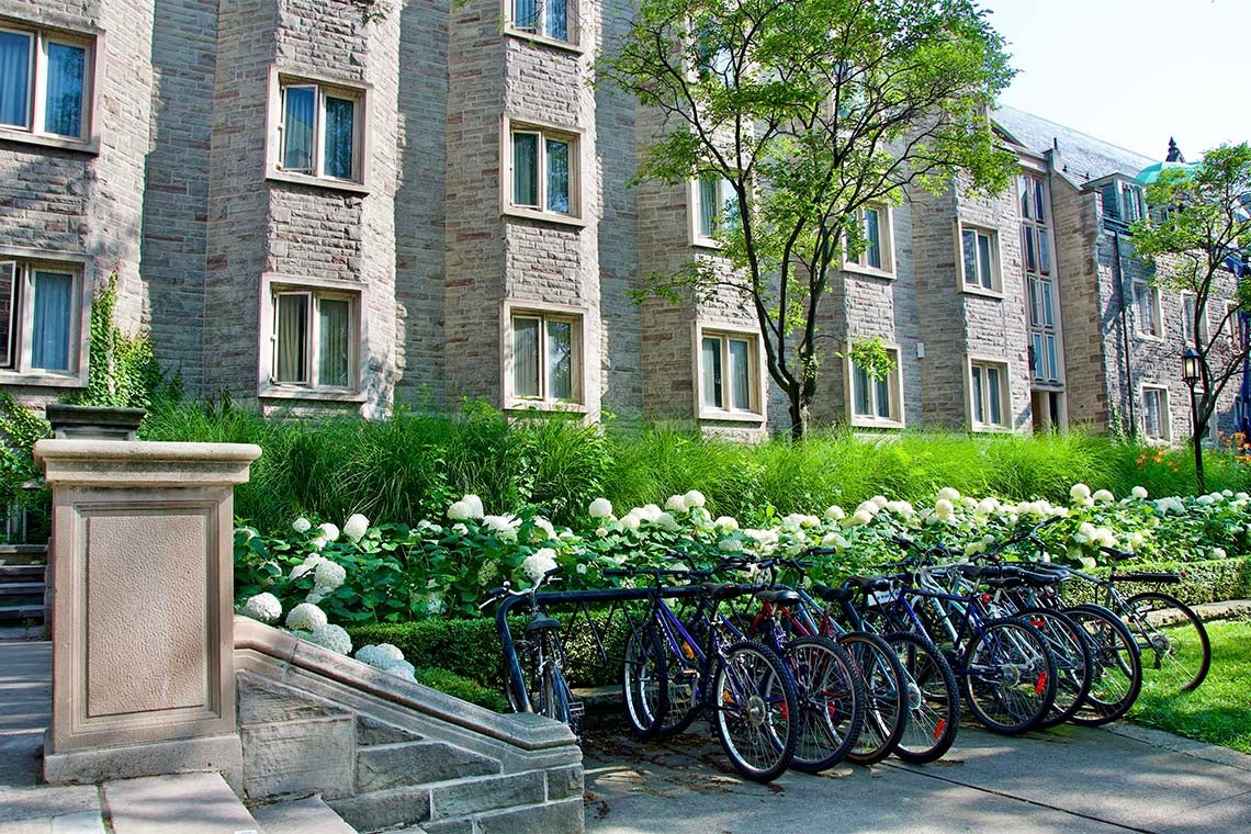 Photos of bicycles locked up outside of a building on campus