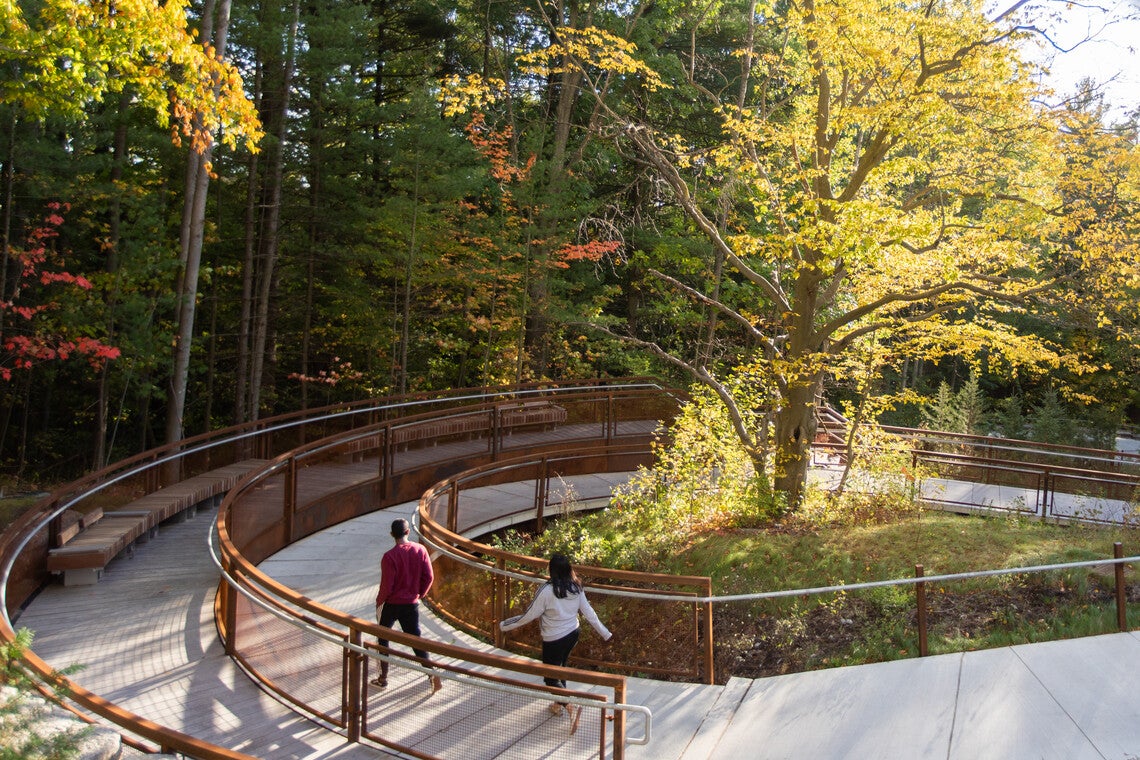 two students walk along the UTSC Valley Land Trail