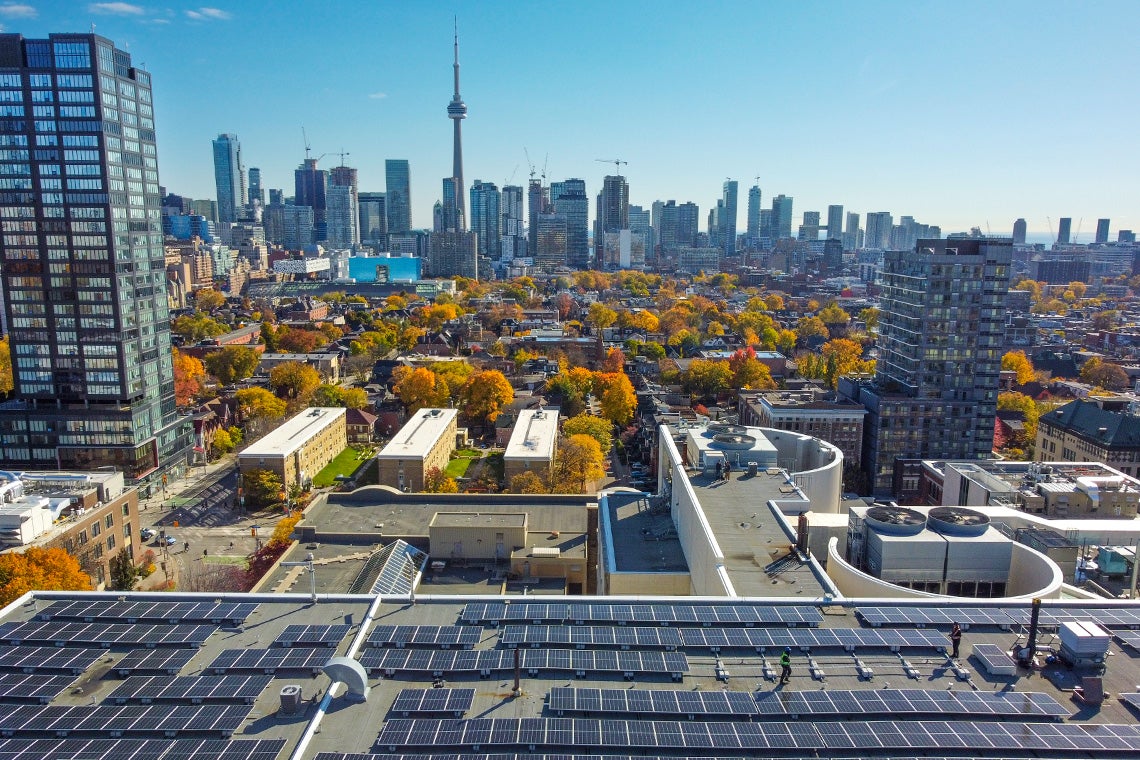 toronto skyline with a u of t solar panel roof in the foreground