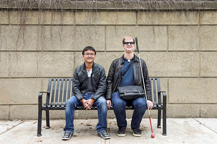 Bin Liu of iMerciv and Rylan Vroom sitting on a bench