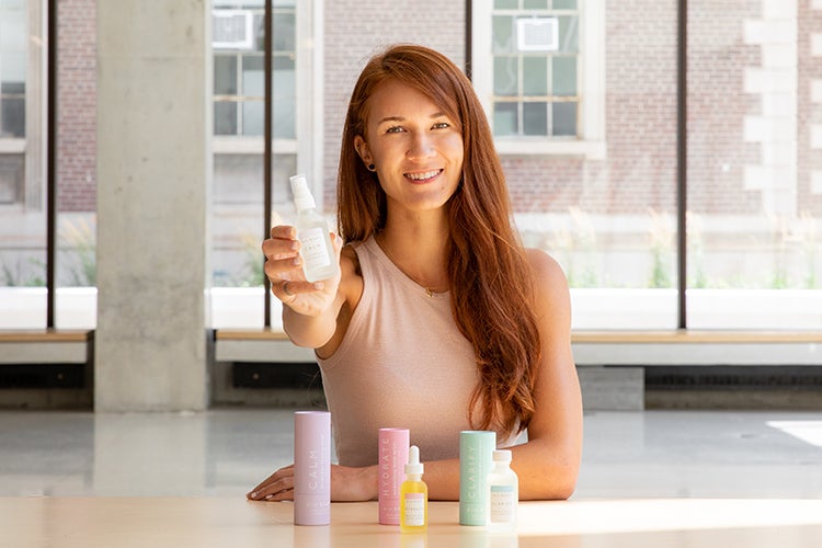 Laura Burget of Niu Body olds up one of her products for the camera