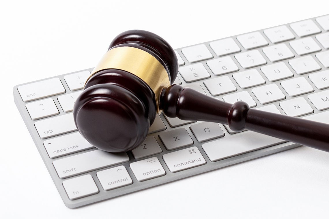 Symbolizing machine learning for lawyers, a judge’s gavel rests on a computer keyboard