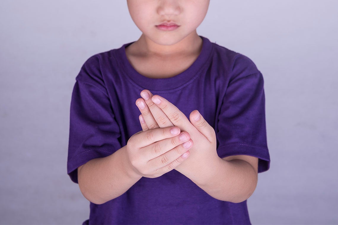 photo of boy grasping fingers