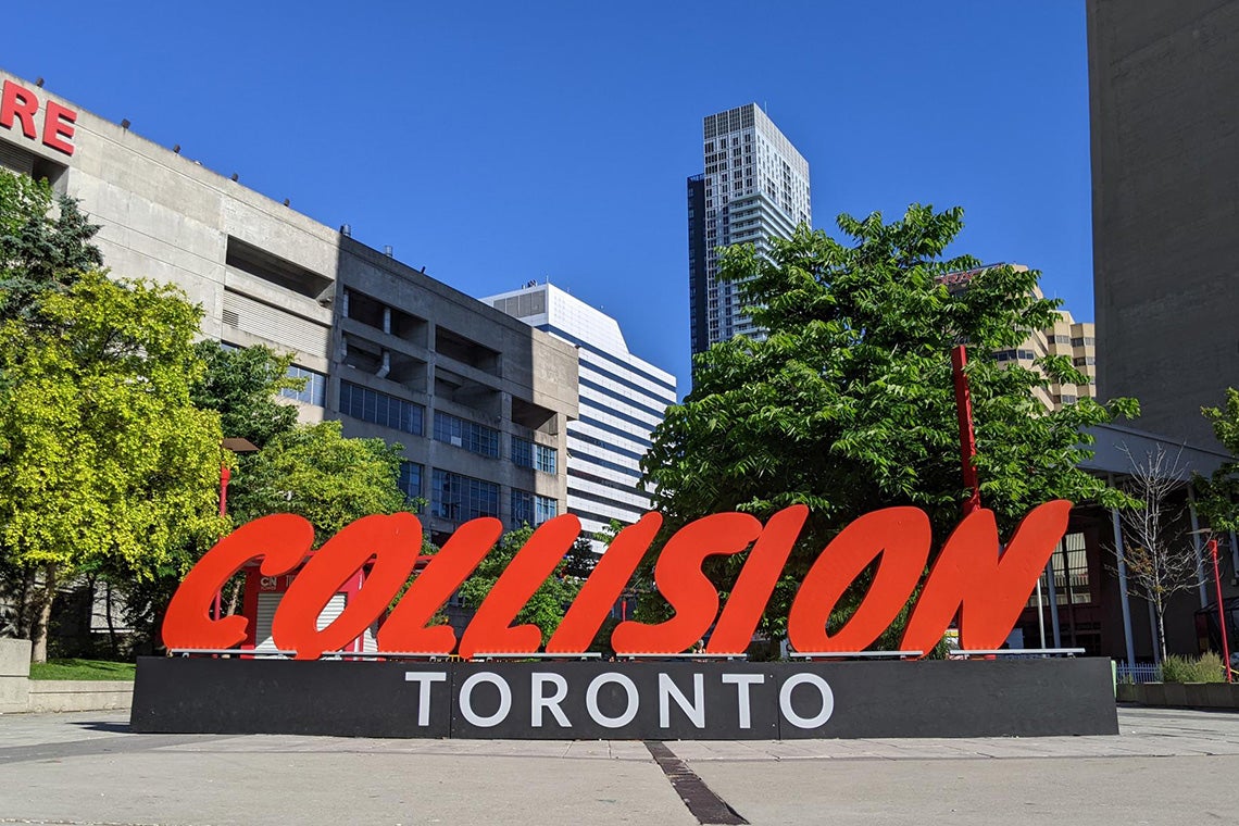 The large Collision conference sign is seen near the Rogers Centre and CN Tower in Toronto