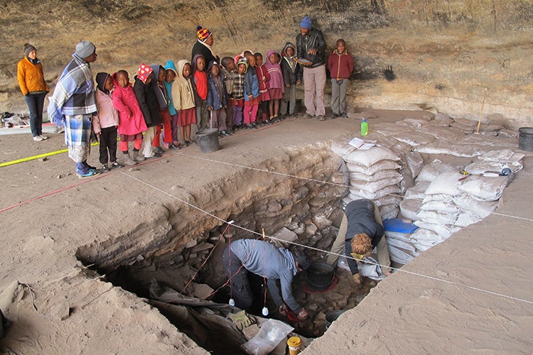 Children look at archaeologists at work