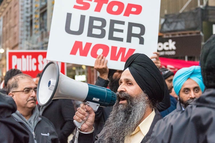 Taxi driver with megaphone protesting against Uber