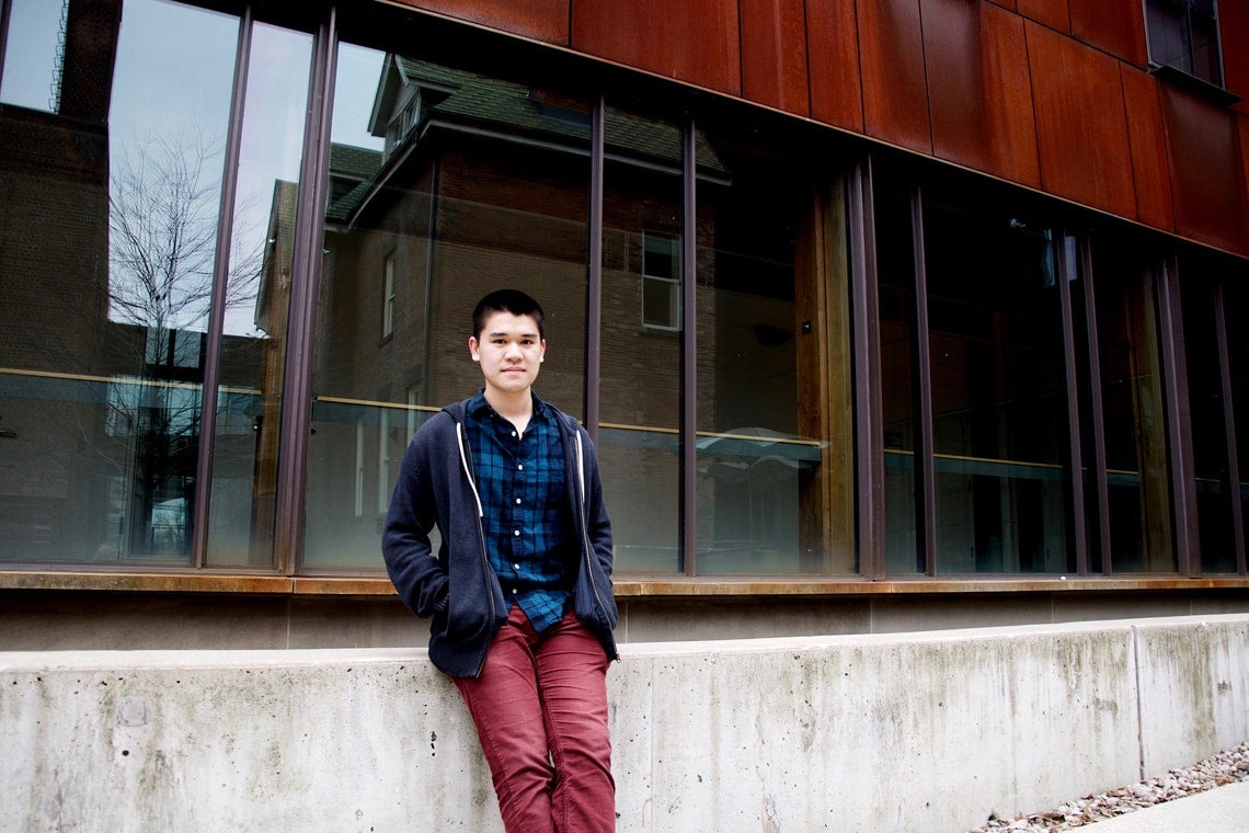 Student Quan Le in front of a building