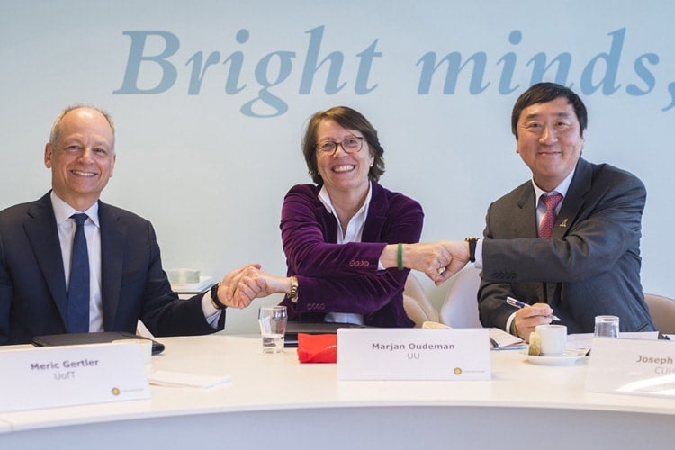 President Gertler shakes hands with the other two university presidents