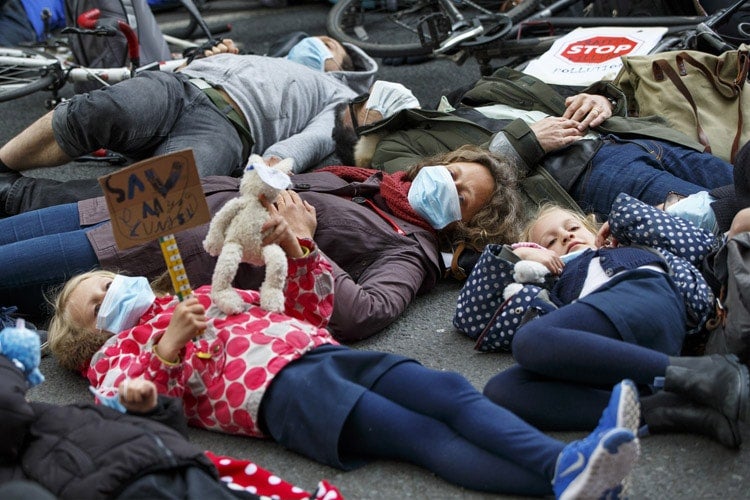 Anti-air pollution protesters lying on the ground in London, England