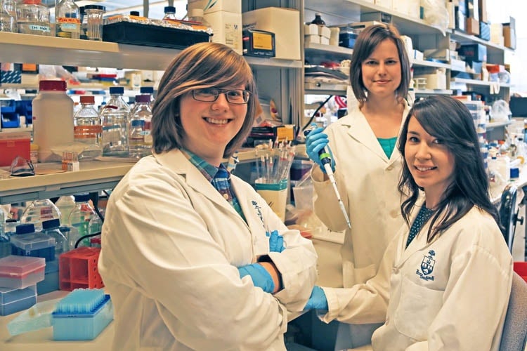 Three researchers (Elliott Donaghue, Malgosia Pakulska, Jaclyn Obermeyer) standing in their lab