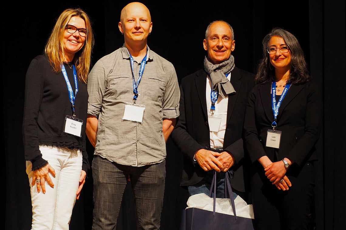 Assistant Professor Mikko Taipale stands between Elisa Nuyten and David Dime. Leah Cowen