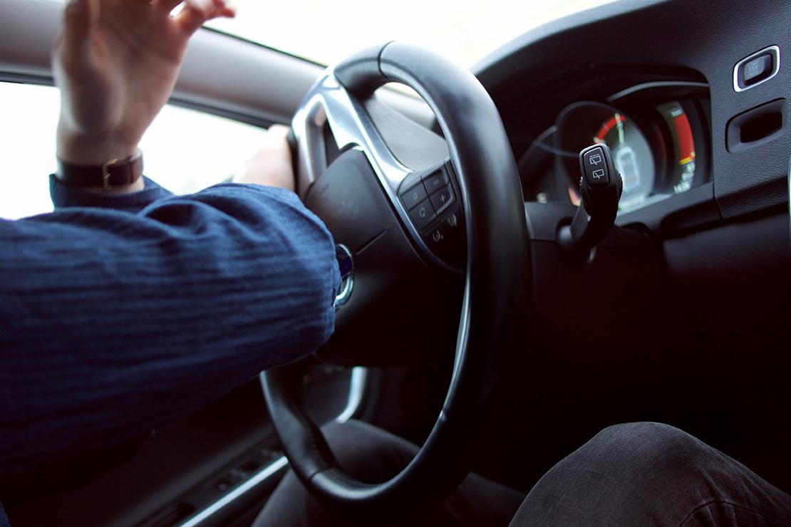 Photo of a driver turning a steering wheel suddenly