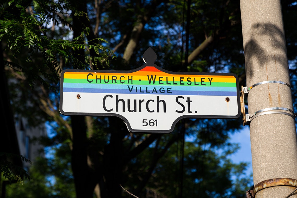 Church st signage in Toronto that has the gay pride flag colours on it