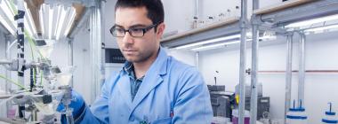 A researcher operates equipment in a lab.