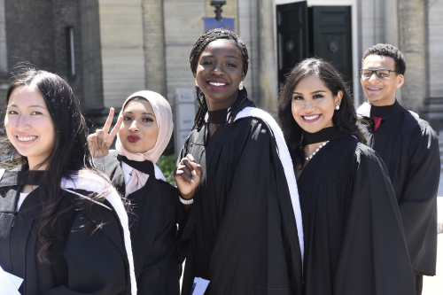 Graduates at convocation posing for a photo.