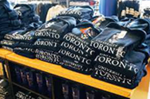 A stack of U of T branded sweatshirts on display