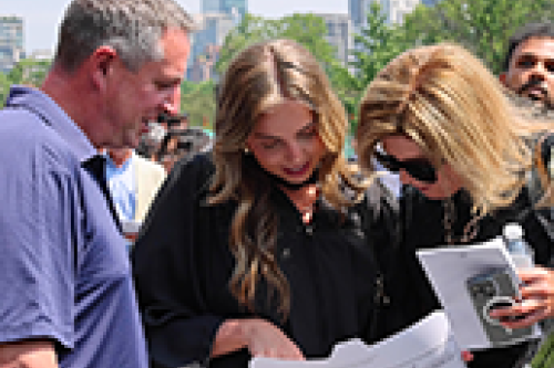 A student and their family look at their diploma