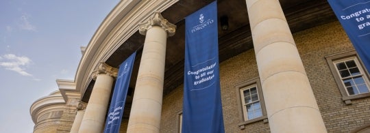 exterior view of convocation hall showing graduation banners