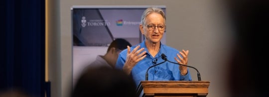 Geoffrey Hinton speaking from the stage at Toronto Tech Week