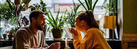 a mixed couple have a romantic date at a cafe