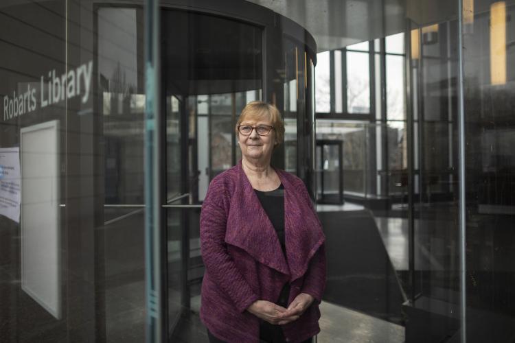 Librarian Lari Langford stands in front of Roberts Library