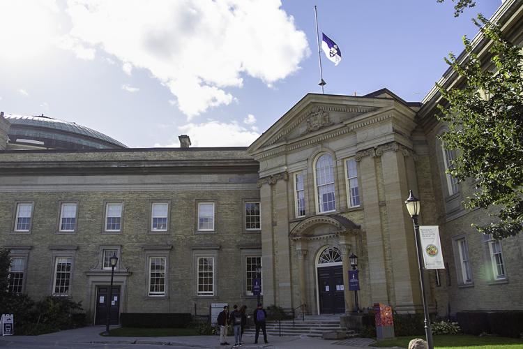 Simcoe Hall with the University flag at half-mast