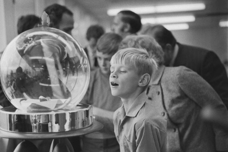 photo of boy looking at lunar samples