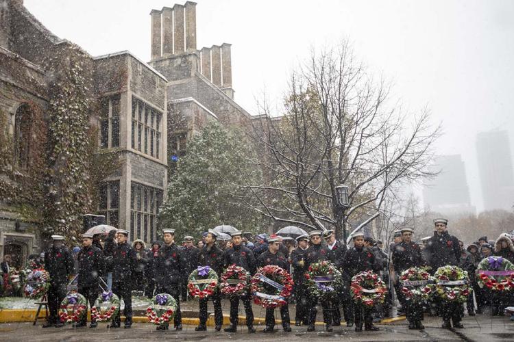 Students hold wreaths outside of Hart House during Remembrance day 2019