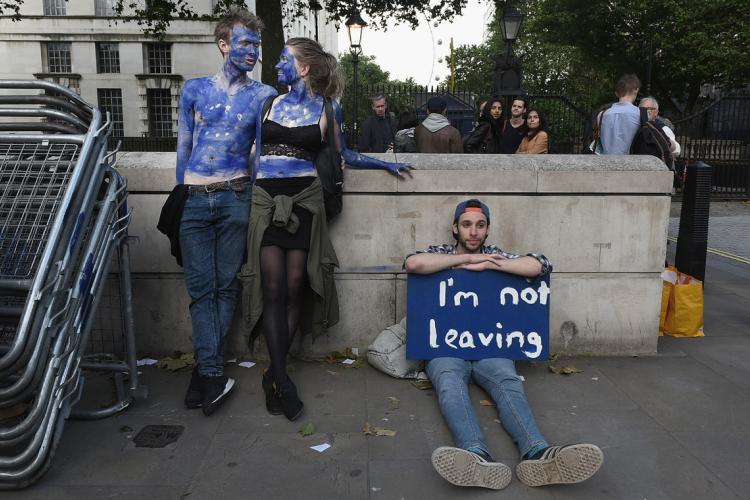 A young couple painted as EU flags protest on outside Downing Street against the United Kingdom's decision to leave the EU following the referendum on June 24, 2016 in London, United Kingdom.