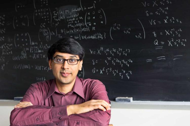 photo of Bhargava in front of blackboard