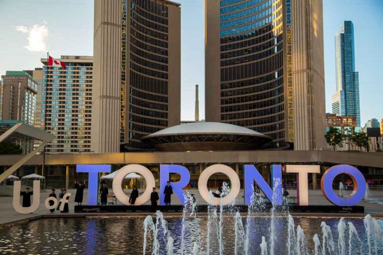 photo of grads at Toronto sign