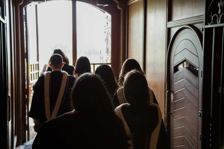 photo of grads exiting university college doors