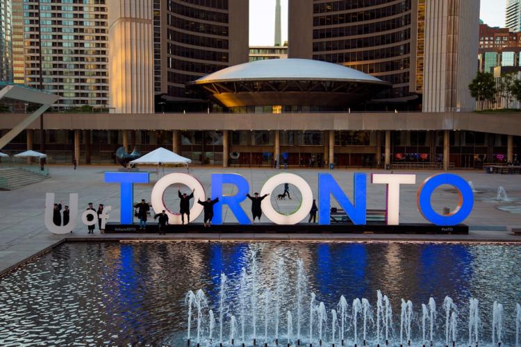 photo of U of T grads with Toronto sign