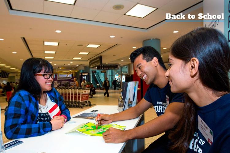 Students at U of T welcome booth at Pearson answer questions for new international students