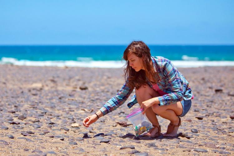 photo of Rochman on beach collecting debris