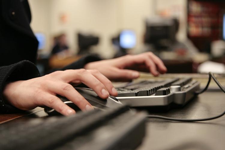 photo of hands at a computer keyboard
