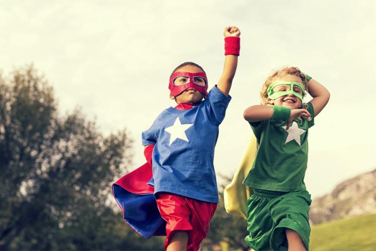 Photo of two children dressed as superheroes