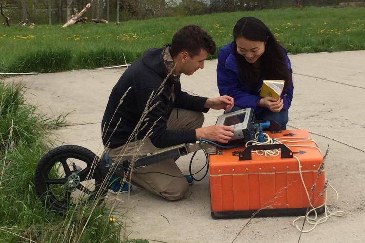 Photo of students taking measurements with ground-penetrating radar
