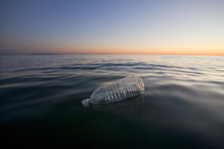photo of plastic bottle in ocean