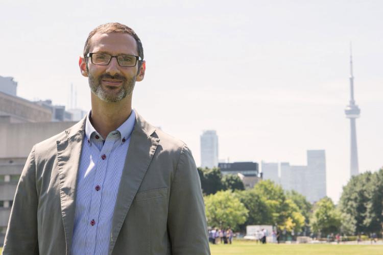 photo of Matti Siemiatycki with Toronto skyline in background