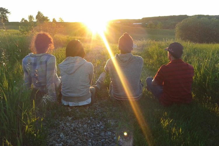Photo of students on farm during sunset