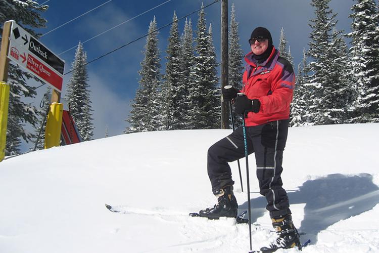 Photo of graduate John Horton on a ski hill