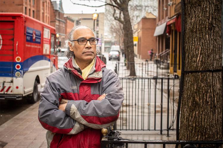 Portrait of Kumar Murty taken at street level outside of his elm st office