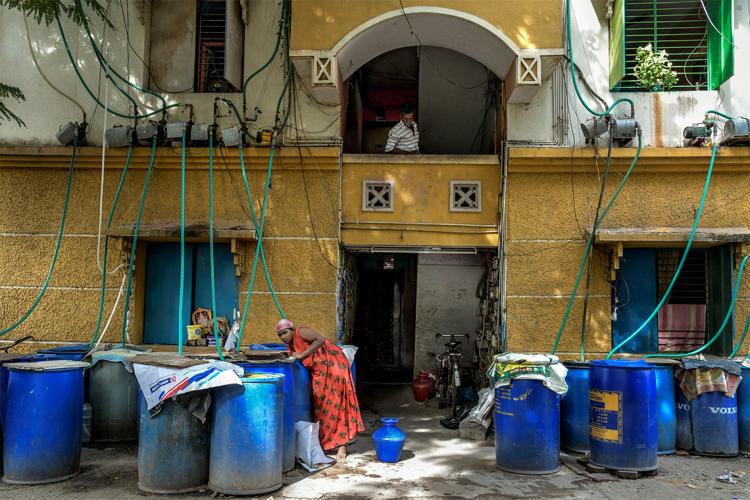 Water barrels outside a building in India.