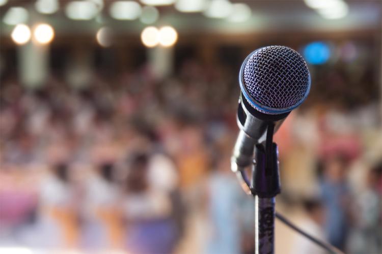 A microphone in front of an audience.