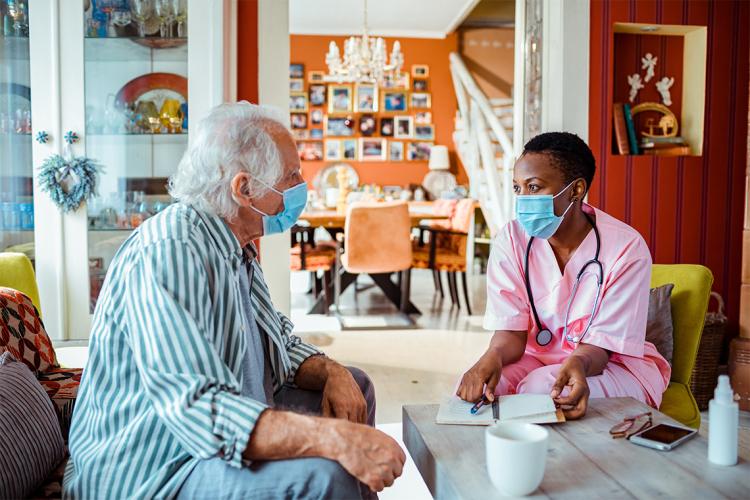a caregiver visits a patient at home