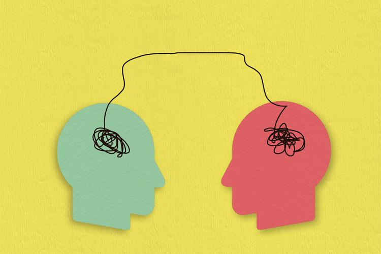 Photo illustration of two paper heads connected to each other by a line
