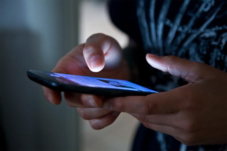 a woman checks her cellphone