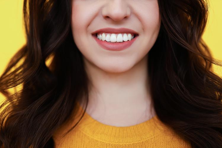 a woman smiling showing white teeth